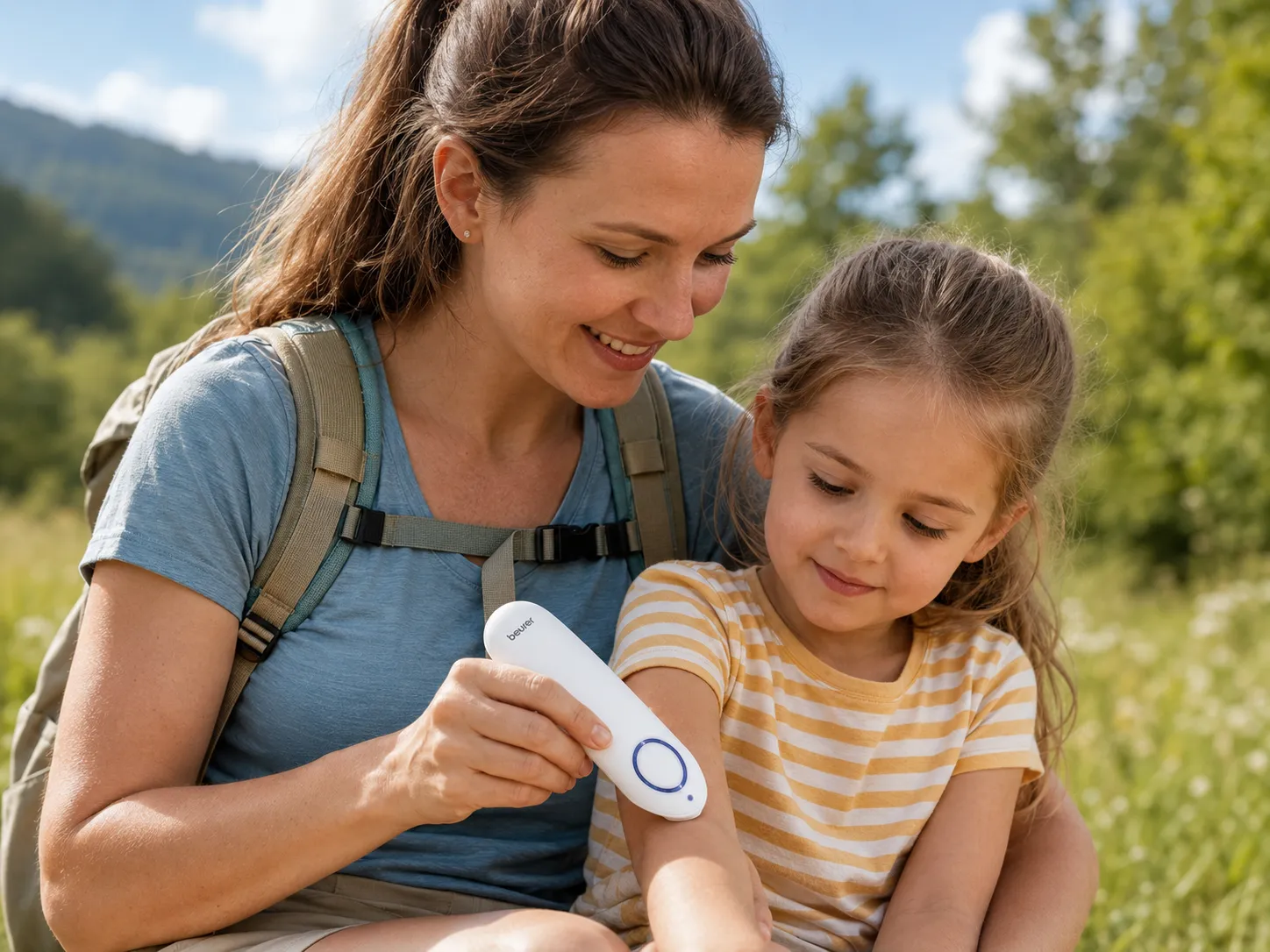 A mother treating her child with the Beurer Insect Bite Healer BR60