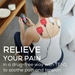 A woman sits on the couch holding EM59 with 4 electrodes on her back. TENS offers drug-free pain relief. 