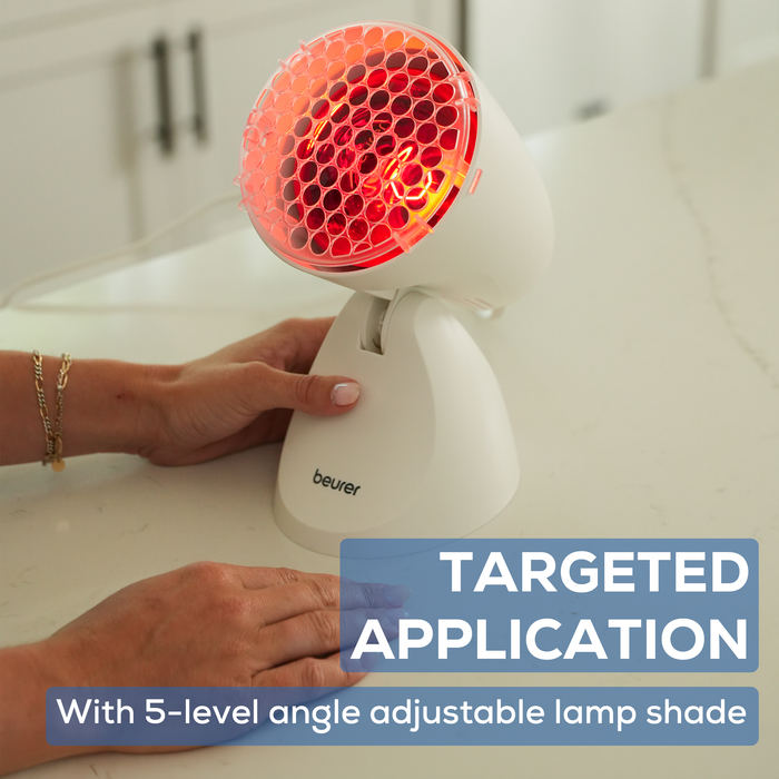 IL11 Infrared Lamp on a white counter. Women adjusting the angle of the lamp for targeted application.